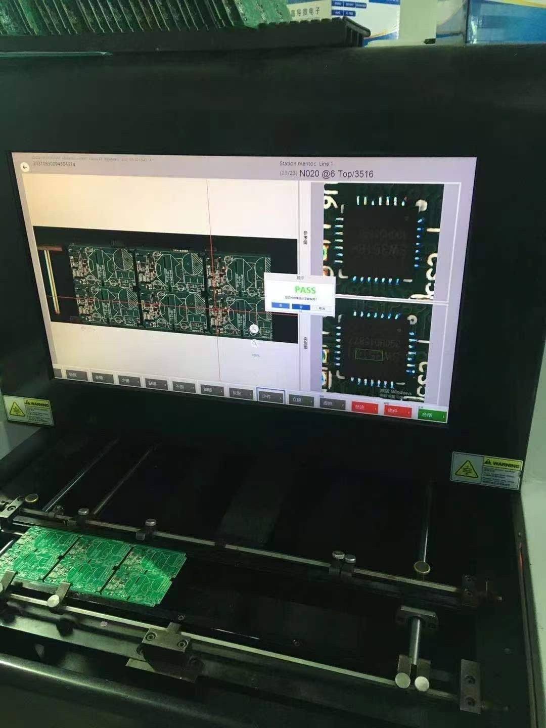 AOI optical inspection station showing a passing cartridge PCB batch