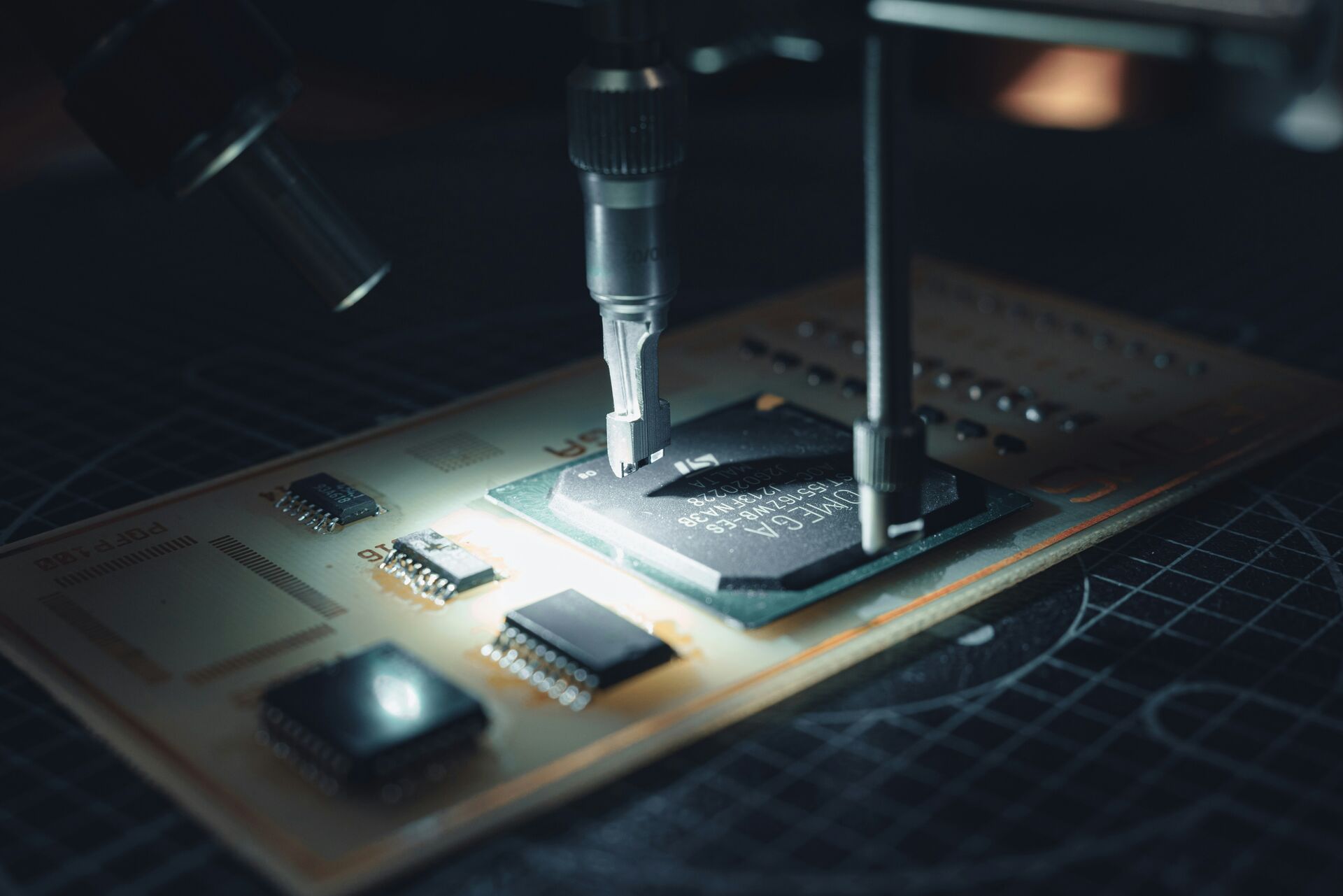 Close-up of a technician programming a retro game cartridge IC in a factory setting.