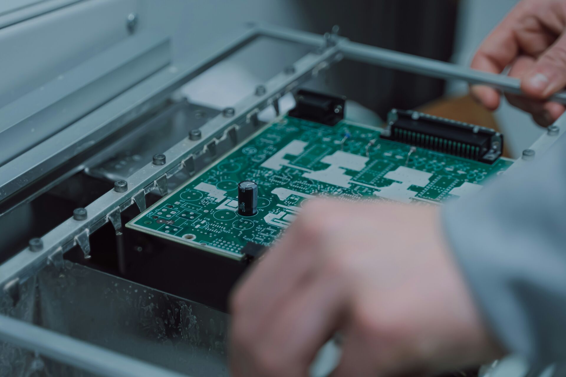 A technician inspecting printed labels before applying them to game cartridges.