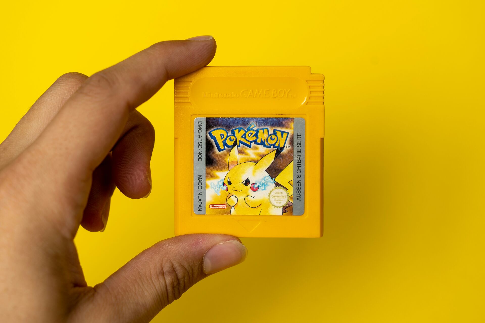 Close-up of a Game Boy Advance cartridge shell with custom label applied.