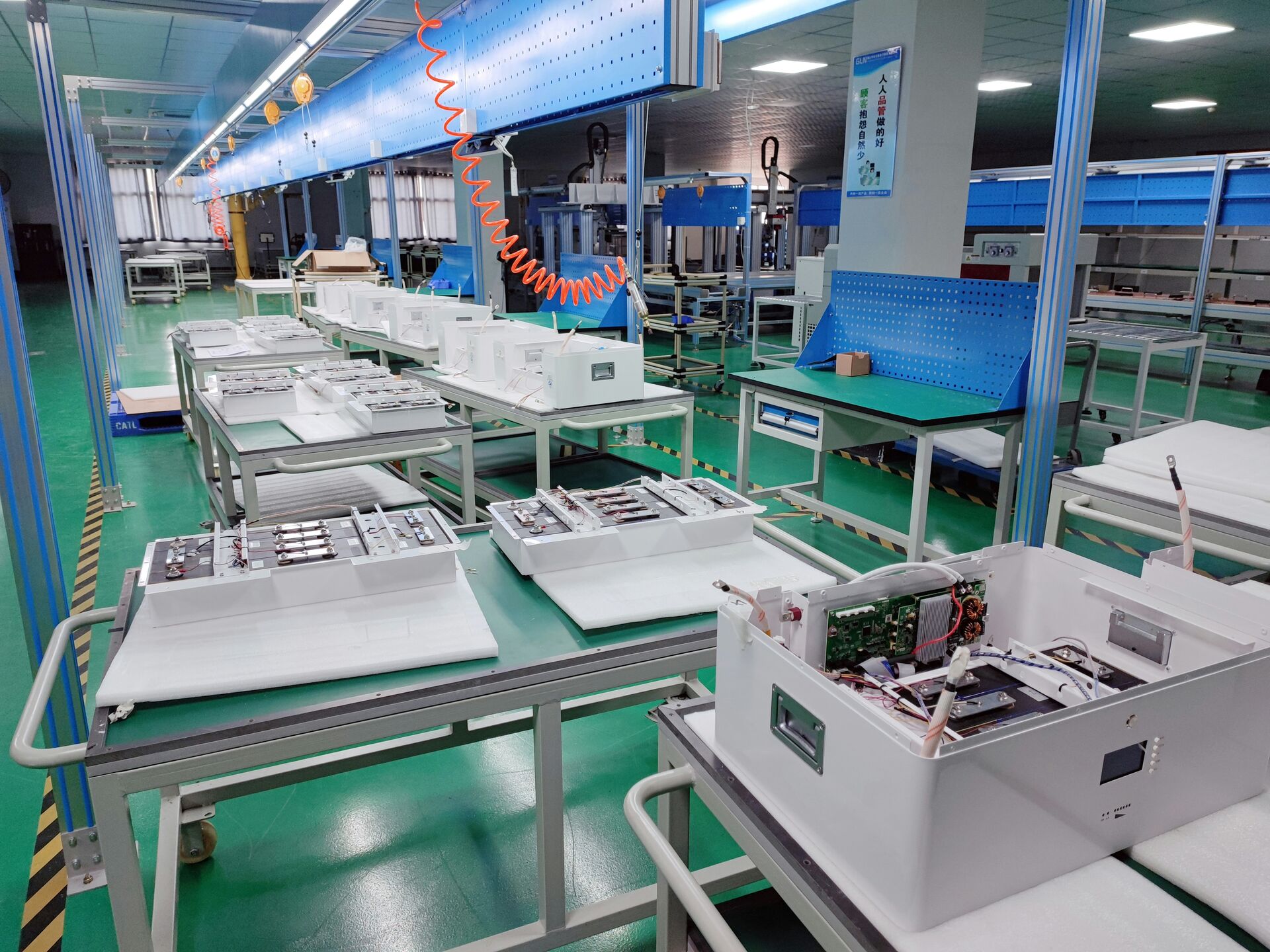 Factory assembly line showing cartridge assembly and quality control checks.